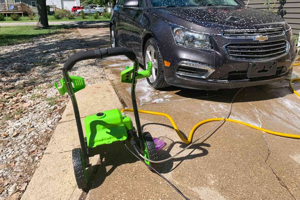 Beginner’s Guide to Using a Pressure Washer for the First Time Beginner using a pressure washer on a car at a car wash in Lagos Nigeria