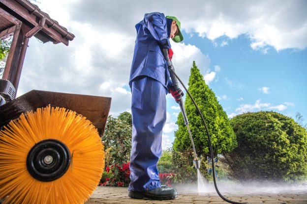 How to Maintain Your Pressure Washer for Long-Term Use Technician inspecting pressure washer hose for cracks before use Lagos Nigeria