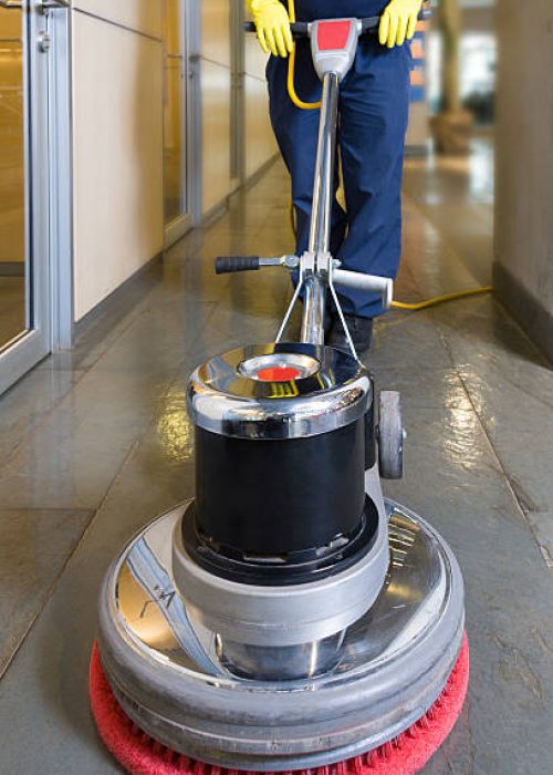 Industrial buffing machine polishing the floor in a hallway
